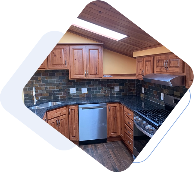 A kitchen with wooden cabinets and black counter tops.